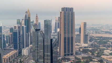 Fototapeta na wymiar Dubai International Financial Centre district with modern skyscrapers day to night timelapse
