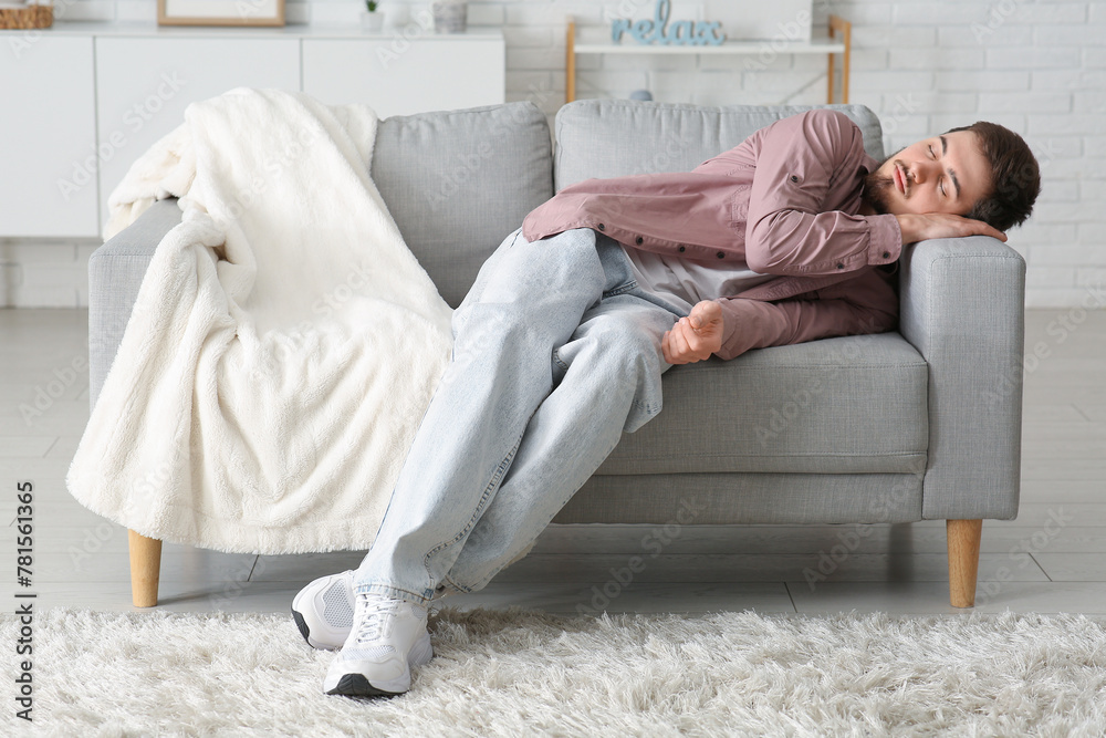 Canvas Prints Tired young man sleeping on sofa at home