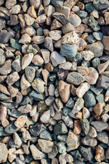 The background is made of stones of different sizes and colors. The texture of natural stones.