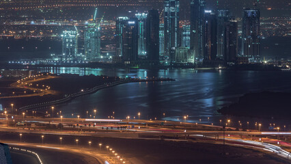 Obraz premium Construction of new skyscrapers in Dubai Creek Harbor aerial night timelapse. Dubai - UAE.