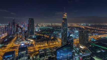 Naklejka na ściany i meble Dubai International Financial Centre district with modern skyscrapers night to day timelapse