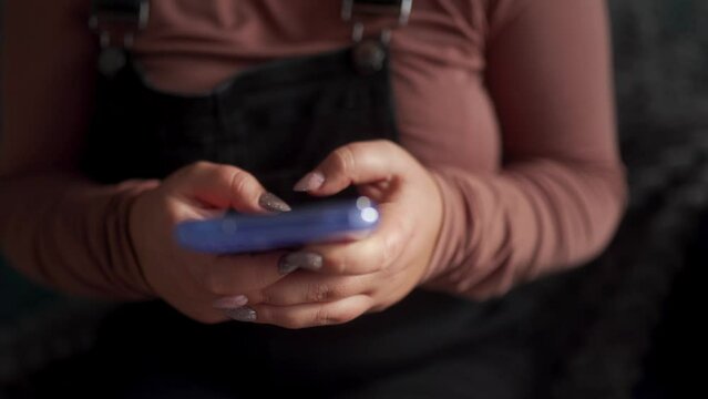 Close-up, woman texting on smartphone. Focused on mobile communication, tech-savvy user engaged in social media, networking. Modern lifestyle with digital devices, connectivity in daily routine.