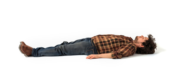 Man Sleeping concept. Eyes closed. Plaid shirt and jean pants. Laying on the isolated white background. Can also represent Fainted, dead, relaxed, relaxation, drunk.