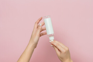 Cosmetic bottle in woman's hand. Cosmetic product branding mockup. Daily skincare and body care...