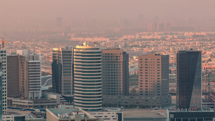 Fototapeta na wymiar Dubai's business bay towers at morning aerial timelapse.