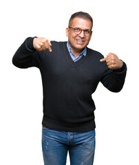 Fototapeta premium Middle age bussines arab man wearing glasses over isolated background looking confident with smile on face, pointing oneself with fingers proud and happy.