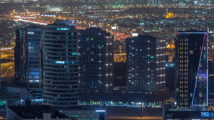 View of bright lights on tall skyscrapers near highways in Dubai city, United Arab Emirates...