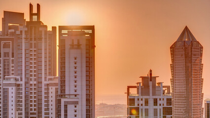 Sunset behind modern residential and office complex aerial timelapse at Business Bay, Dubai