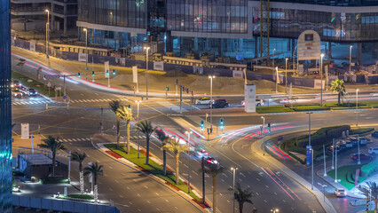 Top view city traffic on a crossroad in Dubai Business bay night timelapse.