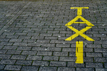 yellow taxi sign on sidewalk