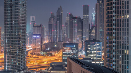 Aerial view of new skyscrapers and tall buildings in Dubai night to day timelapse