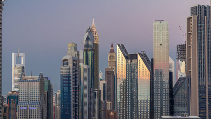 Naklejka premium Aerial view of new skyscrapers and tall buildings in Dubai day to night timelapse
