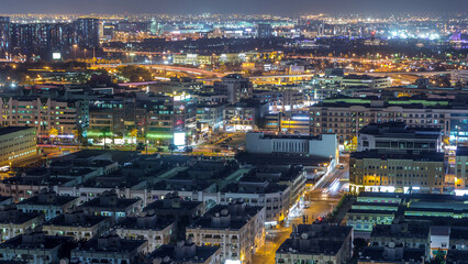 Aerial view of neighborhood Deira with typical buildings night timelapse, Dubai, United Arab...