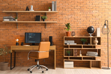 Interior of modern office with programmer's workplace and shelves