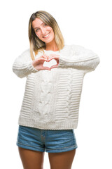 Young beautiful woman wearing winter sweater over isolated background smiling in love showing heart symbol and shape with hands. Romantic concept.