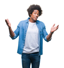 Afro american man over isolated background clueless and confused expression with arms and hands...