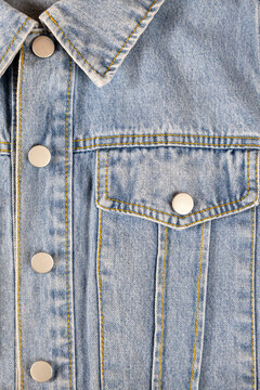 Denim jacket collar and pocket, texture background.