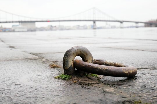 Boat mooring ring on the quay with the bridge in the background.