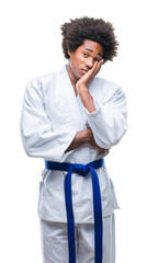 Afro american man wearing karate kimono over isolated background thinking looking tired and bored...