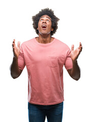 Afro american man over isolated background crazy and mad shouting and yelling with aggressive...
