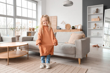 Cute little girl in adult clothes at home