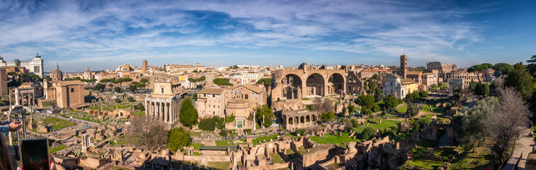 Fototapeta na wymiar Aerial panoramic view from Palatine Hill. Roman Forum, Cityscape, sunny day ancient Rome, Arch of Severus, temple of Saturn, temple of Vesta, Basilica of Maxentius, Arch of Titus and. Italy.