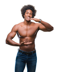 Fototapeta premium Afro american shirtless man showing nude body over isolated background gesturing with hands showing big and large size sign, measure symbol. Smiling looking at the camera. Measuring concept.