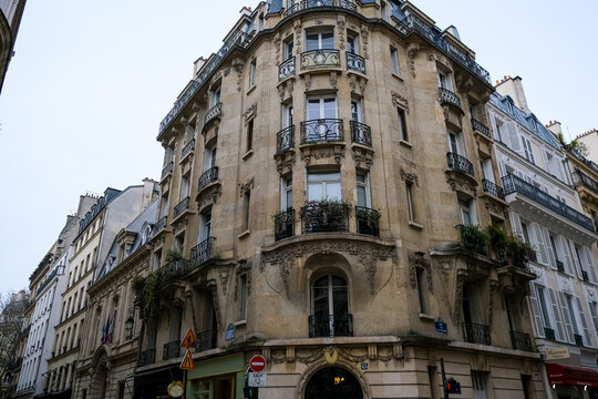 Paris, France - 21.02.2024. Street view and facade of charming Parisian residential building in Solferino area in Paris. Cross between Rue de l'Université and Rue de Bellechasse.