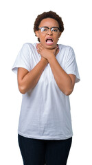 Beautiful young african american woman wearing glasses over isolated background shouting and suffocate because painful strangle. Health problem. Asphyxiate and suicide concept.