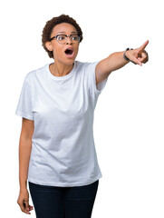 Beautiful young african american woman wearing glasses over isolated background Pointing with finger surprised ahead, open mouth amazed expression, something in front