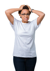 Beautiful young african american woman wearing glasses over isolated background Crazy and scared with hands on head, afraid and surprised of shock with open mouth
