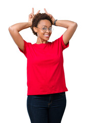 Beautiful young african american woman wearing glasses over isolated background Posing funny and crazy with fingers on head as bunny ears, smiling cheerful