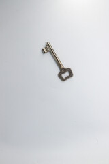 Close up of a key, white background.