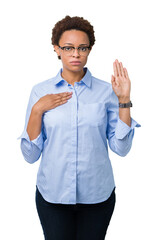 Young beautiful african american business woman over isolated background Swearing with hand on...