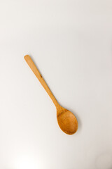Wooden spoon on isolated, white background.