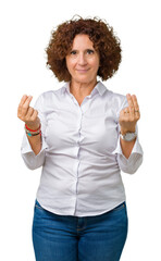 Beautiful middle ager senior businees woman over isolated background Doing money gesture with hand,...