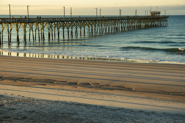 Pier on NC coast with long shadows