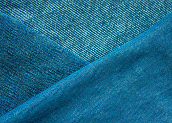 Background from fabric blue jeans of different shades and brightness. jeans texture. Jeans texture. Jeans background. Denim texture or denim jeans background.