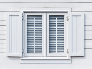 Texture-rich white wood shutters against a clean background