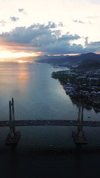 Aerial View of Iconic Merah Putih Cable Stayed Bridge accross Ambon Bay and Wai Ruhu Galala Yellow Truss Bridge. 