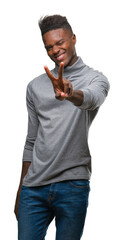 Young african american man over isolated background smiling looking to the camera showing fingers doing victory sign. Number two.