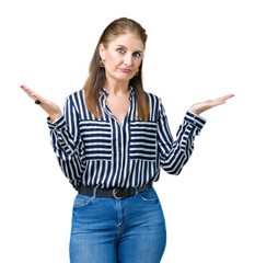 Middle age mature business woman over isolated background clueless and confused expression with...