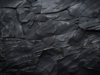 The background is adorned with a closeup of black slate texture