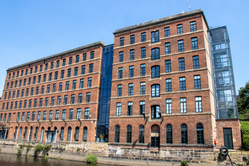 A converted mill by the canal in the city of Leeds on a hot sunny summers day © Duncan