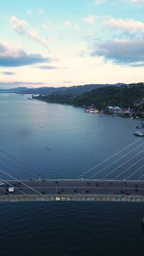 Aerial View of Iconic Merah Putih Cable Stayed Bridge accross Ambon Bay and Wai Ruhu Galala Yellow Truss Bridge. 