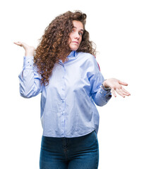 Beautiful brunette curly hair young girl wearing elgant look over isolated background clueless and...