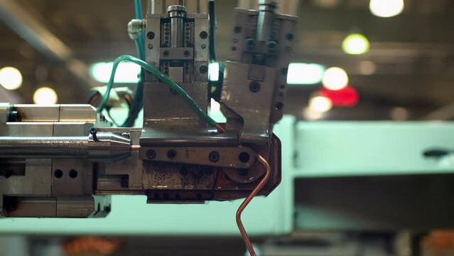 Automatic Tube Bender, A CNC Copper Pipe Bending Machine in Fridge Factory. Close Up. 4K Resolution.