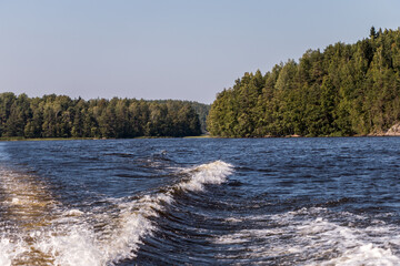 view from a motor boat of the water of Lake Ladoga and rocky islands. Ladoga skerries. Beautiful landscape	