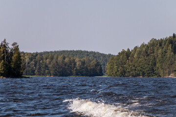 view from a motor boat of the water of Lake Ladoga and rocky islands. Ladoga skerries. Beautiful landscape	