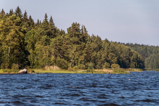 view from a motor boat of the water of Lake Ladoga and rocky islands. Ladoga skerries. Beautiful landscape	
